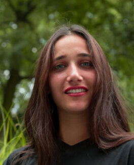Outdoor portrait of mixed race Indian woman standing outdoors. Close up.